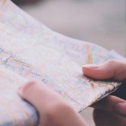 A woman's hands hold a road map