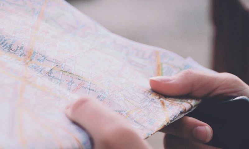 A woman's hands hold a road map