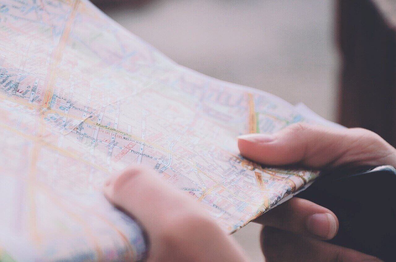 A woman's hands hold a road map